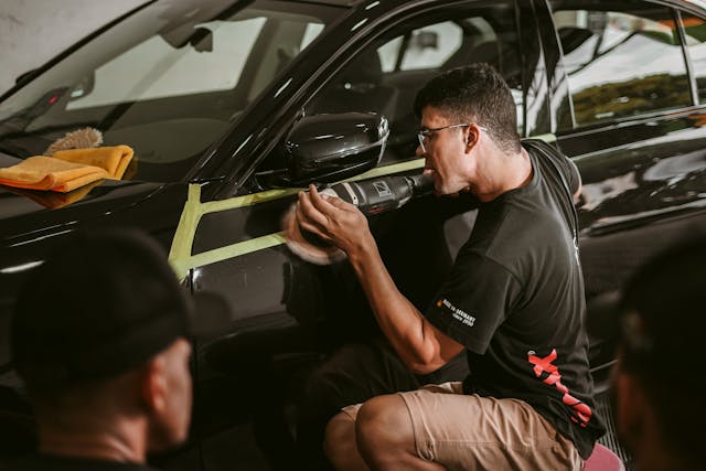 Detailing polish work on a dark vehicle