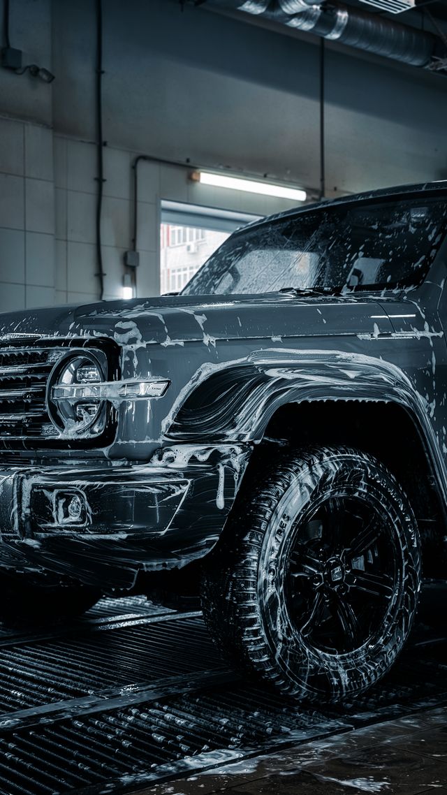 Foam wash on a dark SUV